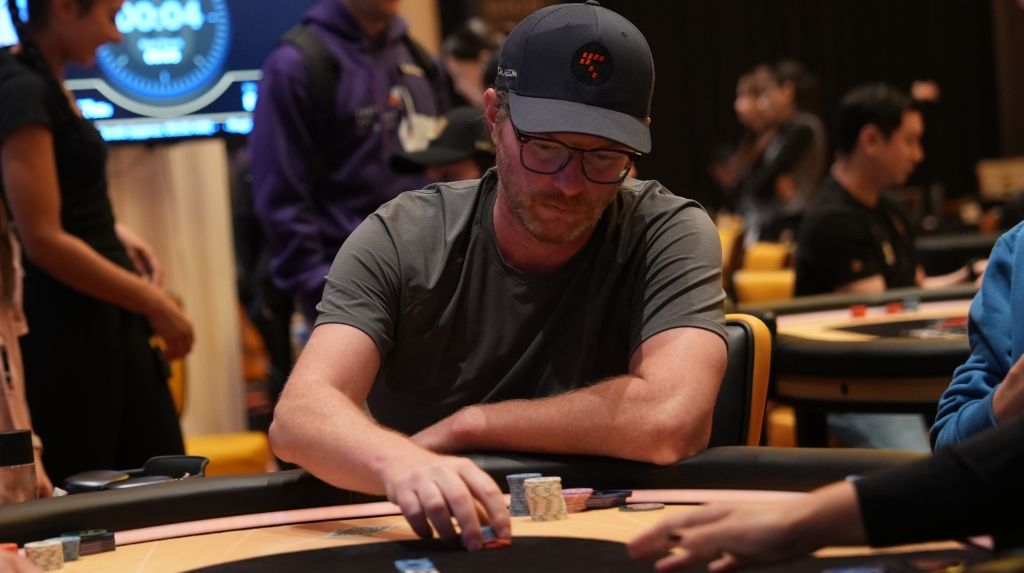 Nick Petrangelo at a live poker table, focused on his chips.